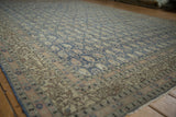 Distressed vintage Sivas carpet's repeating boteh design in denim blue and antique ivory.
