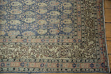 Distressed vintage Sivas carpet corner, denim blue field, antique ivory boteh, sandalwood border.