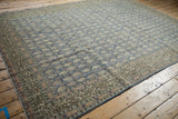 Vintage Sivas rug corner with ornate beige border and blue field featuring distressed boteh motifs.