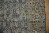 Distressed Sivas carpet: dark blue boteh field and geometric borders in sand, rust, green.