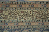 Distressed vintage Sivas carpet border, revealing faded navy, seafoam, and floral ivory patterns.