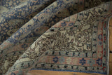 Distressed vintage Sivas carpet, showing softened pile and faded floral border in denim blue and sandalwood.