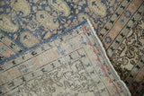 Distressed Sivas carpet corner with faded blue pile, hand-knotted foundation, and fringe.