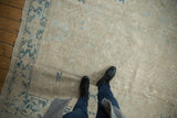 Distressed Gorevan carpet: ivory geometric field with subtle vinery and a blue Samovar border.