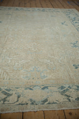 Distressed Gorevan carpet close-up, showing muted ivory, beige, blue geometric patterns, and Samovar border.