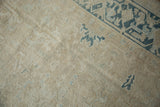 Distressed Gorevan carpet texture, visible knot heads, and fading denim blue geometric motifs.