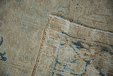 Distressed Gorevan wool pile with visible foundation, showing ivory, sand, and blue tones.