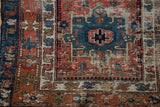 Worn antique Karaja runner: indigo geometric motif, brick red field, and checkered vinery border.