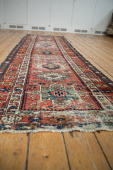 Worn texture of antique Karaja runner, with brick red field and geometric motifs.