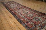 Antique Karaja runner detail: colorful main border with checkered vinery in brick red and indigo.