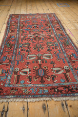 Borchalou runner detail showing brick red field with complex stylized motifs and blue border.