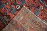Vintage Borchalou rug showing patterned red pile, blue details, and hand-knotted foundation weave.