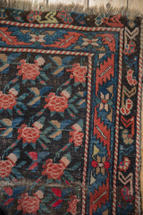 Antique Karabagh rug corner, madder root red rose lattice, geometric indigo border, thin pile.
