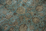 Distressed vintage Tabriz carpet detail: dusty aqua blue field, sprawling palmette vinery.