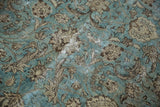 Distressed texture of a vintage rug with dusty aqua blue field and beige palmette vinery.
