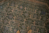 Distressed Shiraz carpet, geometric floral arabesques in dusty blue, forest green, and tan.