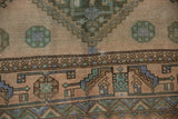 Distressed geometric patterns on a vintage Shiraz rug with dusty sandalwood, blue, green.
