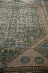 Close-up of distressed vintage Shiraz rug showing geometric patterns, stepped borders, and subtle color abrash.