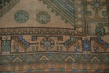Textured pile of vintage Shiraz carpet with geometric floral and chevron patterns.
