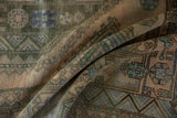 Varied pile texture and geometric motifs on a folded Distressed Shiraz carpet.