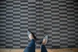 Hand woven Pakistani Kilim rug with geometric charcoal and silver rectangular pattern, abrashes visible.