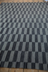 Pakistani Kilim rug close-up: alternating silver and charcoal rectangular pattern with abrashes.