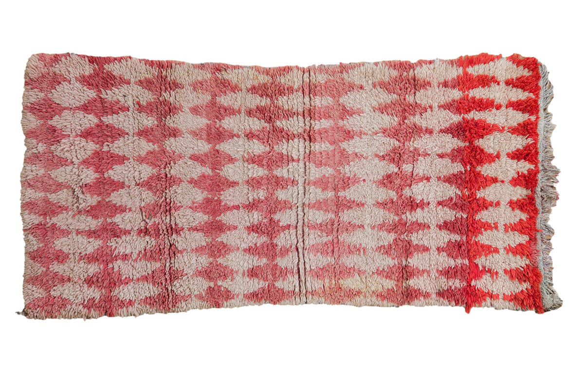 Vintage Moroccan rug with a repeating argyle diamond design and color abrashes in raspberry, ivory, and red.