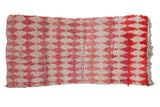 Vintage Moroccan rug with a repeating argyle diamond design and color abrashes in raspberry, ivory, and red.