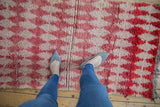 Overhead view showing the shaggy, high-pile texture of the vintage Moroccan rug.