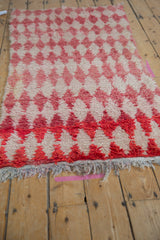 Angled view of a Moroccan rug's plush pile and color abrash across its diamond pattern.