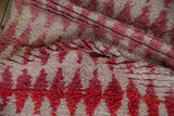 Intact side cord selvage and plush, shaggy pile of a vintage Moroccan rug.