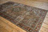 Vintage Distressed Malayer rug corner with charcoal, sandalwood, and rust patterns.