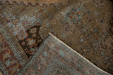 Distressed vintage Malayer rug corner, showing worn sandalwood pile, visible foundation, and woven back.