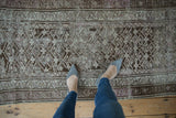 Distressed vintage Caucasian runner with muted silver, brown, and fuchsia geometric plant pattern.