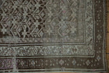 Distressed vintage Caucasian runner corner: geometric plant motif, border, silver, charcoal, mauve.