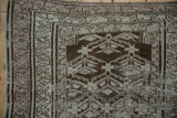 Vintage Distressed Caucasian runner, silver and charcoal plant motif, aged texture.