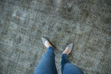 Distressed Sparta rug with heavy wear to foundation, showing muted silver and charcoal tones.