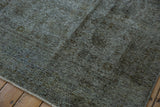 Distressed texture with oxidized silver tones and visible foundation on vintage Sparta carpet.
