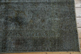 Distressed texture of the Sparta carpet with wear to foundation and fringe.
