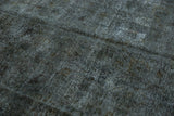 Close detail of distressed overdyed pile, revealing foundation wear in oxidized silver tones.