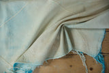 Draped hand woven Turkish Kilim rug, revealing texture and original blue fringe.