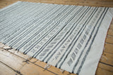 Vintage Moroccan Kilim with striated lines and charcoal, ivory geometric patterns.