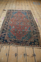 Close-up of vintage Heriz runner: madder red field, sapphire blue floral motifs, serrated border.