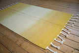 Saffron yellow to pale dusty gold ivory abrash fade on Moroccan rag rug.