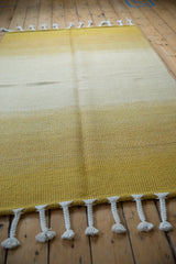 Thick braided ivory fringe detail on the Moroccan rag rug.