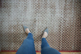 Vintage Sparta rug with scalloped lattice pattern in ivory, pale red, and charcoal, showing foundation.