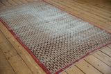 Vintage Sparta rug's scalloped lattice design with time-softened ivory, red, and charcoal tones.