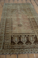Distressed vintage Oushak runner's lower prayer motif and intricate geometric borders.