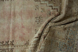 Distressed vintage Oushak rug texture with soft dusty rose, beige, and slate blue.