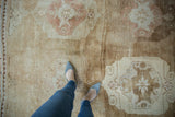 Distressed Kars square carpet pile, faded oversized medallions, and abrashed coffee brown.